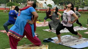 People practice yoga at a park in Lucknow, Uttar Pradesh on June 18, 2017.