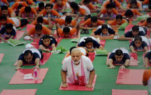 Prime Minister Narendra Modi performs yoga during a mass yoga event on 3rd International Yoga Day in Lucknow on Wednesday.