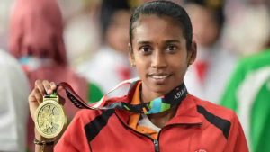 Bronze medallist athlete Chitra poses for photographs at the medal ceremony of women's 1500m event