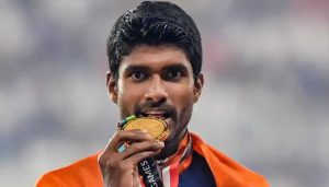 Gold medallist athlete Jinson Johnson poses for photographs during the medal ceremony for the men's 1500m event