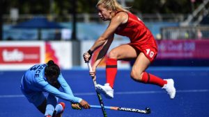 Sophie Bray of England jumps as Deep Grace Ekka of India hits the ball during the womens field hockey match between India and England at the 2018 Gold Coast Commonwealth Games