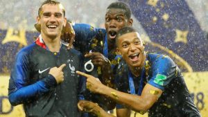 France's Antoine Griezmann, Paul Pogba and Kylian Mbappe celebrate after winning the World Cup.