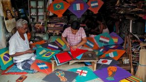 Kite-makers make kites with pictures of the national flags of the countries participating in the upcoming FIFA World Cup in Russia, at a workshop in Kolkata, India