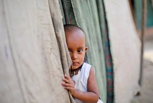 A girl from the Rohingya community stands outside her family's shack in a camp in New Delhi, India October 4, 2018.