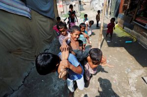 Children from the Rohingya community play outside their shacks in a camp in New Delhi, October 4, 2018