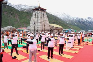 Hindu devotees perform yoga on the occasion of 8th International Day of Yoga at the Kedarnath Temple in Kedarnath on June 21, 2022