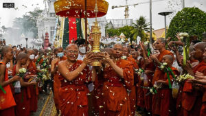 Cambodian Buddhist monks carry an urn which allegedly contains the remains of one of Buddha's bone inside during the Visak Bochea Buddhist celebration at a pagoda in Phnom Penh
