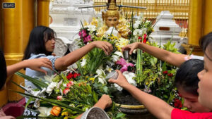 Towering above them was the main, gold-plated spire of the Shwedagon Pagoda, which rises 99 meters (325 feet) into the sky and is believed to house four relics of the Buddha.