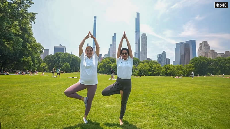 Women pose in Vrksasana or Tree pose to celebrate the 10th International Yoga Day at New York