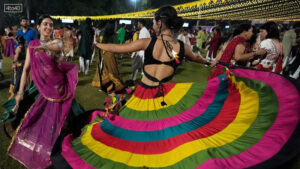 A woman pulls off a beautiful dance move during Garba night