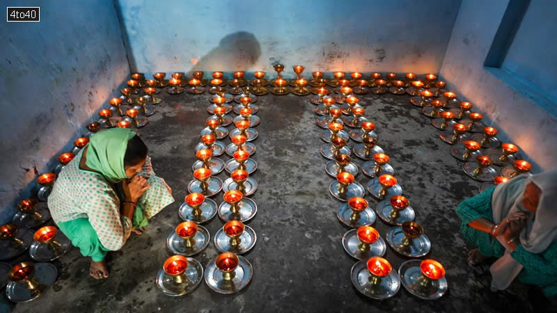 Hindu devotees light lamps at the Baba Sidh Goria temple