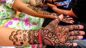 Hindu woman shows her hand decorated with henna ahead of the Karwa Chauth