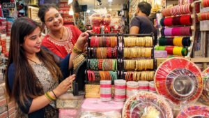 Women purchase bangles from a shop ahead of the Karwa Chauth