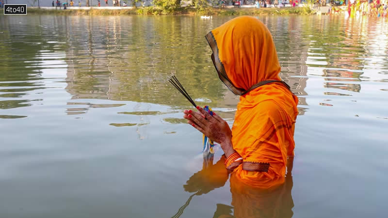 A devotee worships the setting sun in Agartala