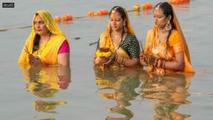 Devotees worship the setting sun during Chhath Puja, at the Ganga Ghat in Kolkata